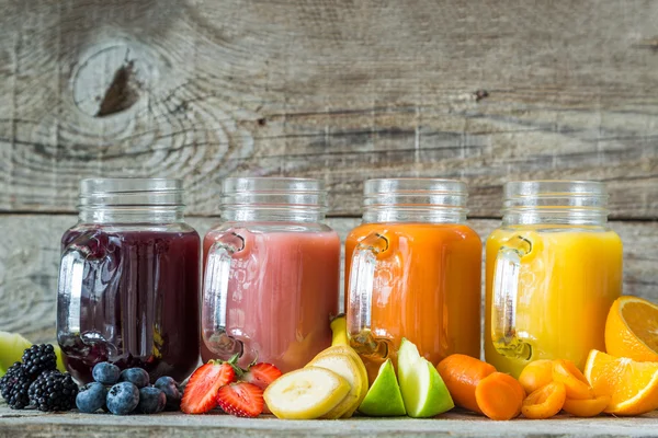 Slection of fresh fruit juices in jars — Stock Photo, Image