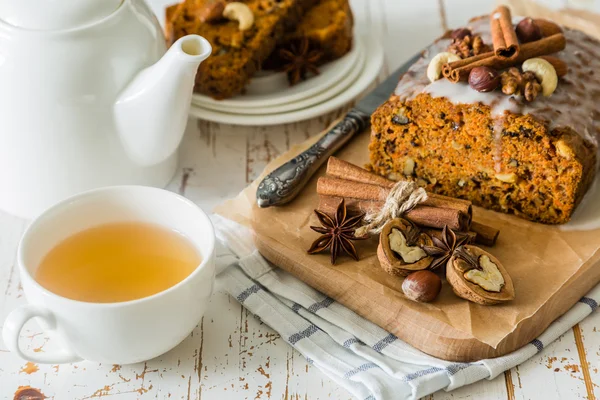 Spicy carrot cake with nuts on wood background — Stock Photo, Image