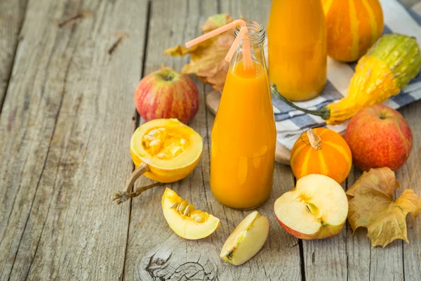 Apple and pumpkin smoothie in glass bottles — Stock Photo, Image