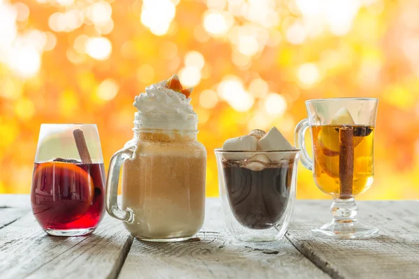 Selection of autumn drinks on wood background