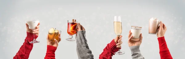 Hands in holiday sweaters holding christmas drinks — 스톡 사진