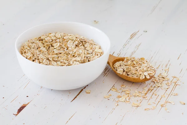 Avena en tazón blanco con cuchara de madera —  Fotos de Stock