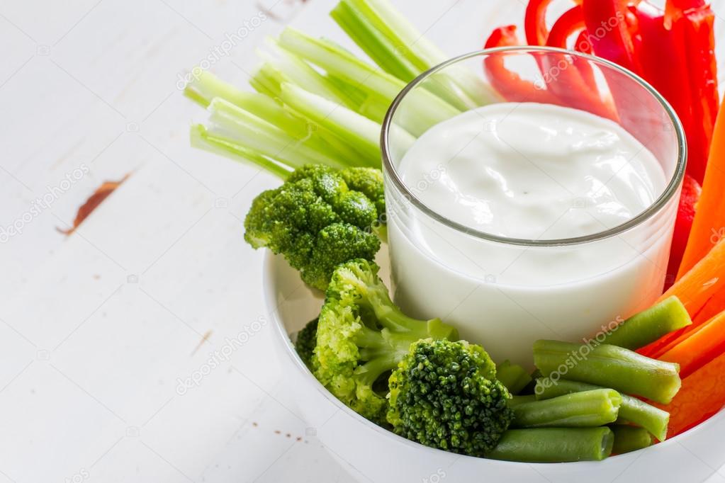 Bowl with vegetables and yogurt sauce