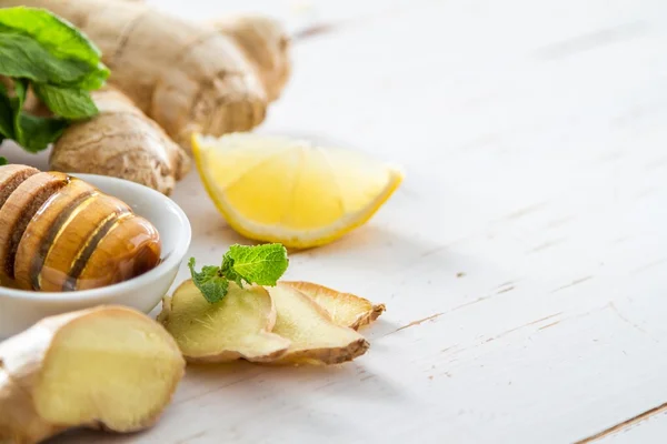 Ginger lemon mint honey on white wood background — Stock Photo, Image