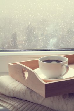 Coffee on tray and sweater