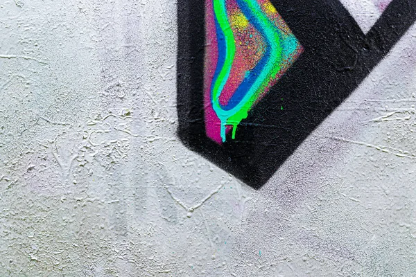 A fragment of colorful graffiti painted on a brick wall. Abstract background for design.