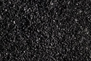 Close-up of black activated carbon texture. Coconut charcoal. clipart