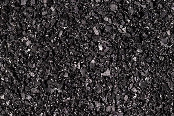 Close-up of black activated carbon texture. Coconut charcoal.