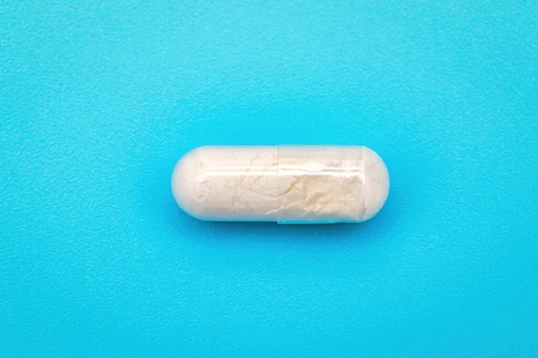 Pillola Bianca Integratore Alimentare Isolato Sfondo Blu — Foto Stock