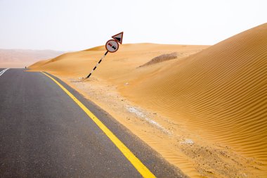 Kum tepeleri Liwa Oasis, Birleşik Arap Emirlikleri üzerinden dolambaçlı siyah asfalt yol