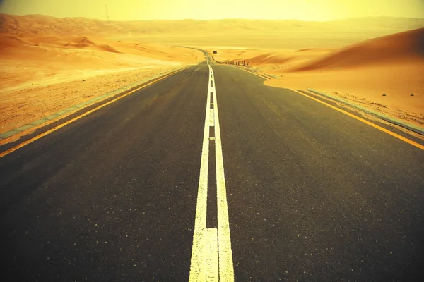 Kanyargós fekete aszfalt úton keresztül a homokdűnék a Liwa oázis, Egyesült Arab Emírségek — Stock Fotó