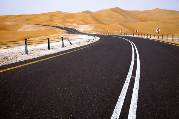 缠绕的黑色沥青路面，通过沙丘的利瓦绿洲，阿拉伯联合酋长国 — 图库照片