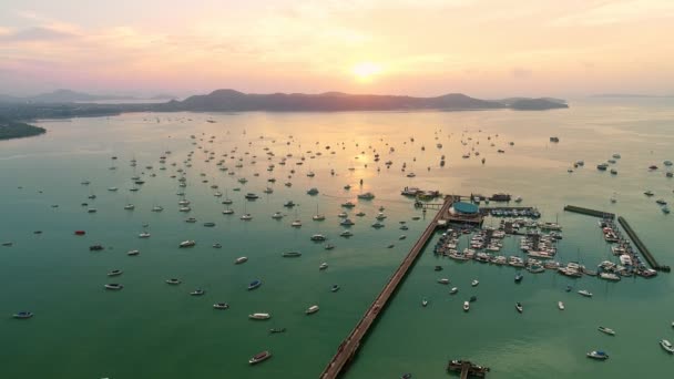 Aerial view drone video shot flying over Chalong pier and Yacht in marina at phuket thailand Beautiful sunrise or sunset light timeTranportation and travel background concept