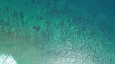 Hava görüntüsü İHA görüntüsü dalgalanır ve açık denizde dalgalanır, üst görünüm deniz kenarı, kamera suyun üzerinde uçar, su yüzeyinin bir görüntüsü, su yüzeyi drone kamera hareketinin arka planı