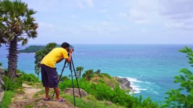 4K Professional man setting Mirrorless Camera taking picture Landscape nature view at Laem Promthep cape Phuket Thailand,Landmark famous tourist destination to see Sunset at Phuket