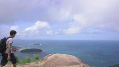 Sırt çantalı genç adam yüksek dağda duruyor ve Phahindum bakış açısına göre Phuket Tayland 'ın ünlü simgesi Phuket Tayland tatil seyahati