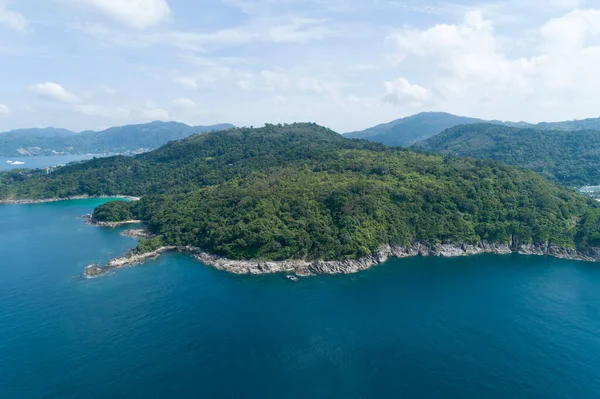 High angle view Tropical sea with wave crashing on seashore and high mountain located in Phuket Thailand aerial view drone top down Amazing nature view landscape Beautiful sea surface