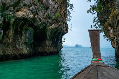 View of Longtail boat Passing Through Hong Island in Krabi Thailand Beautiful island in krabi province. clipart
