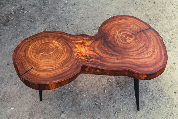 Live edge elm slab coffee table with epoxy finish. Woodworking and carpentry production. Close-up. Furniture manufacture