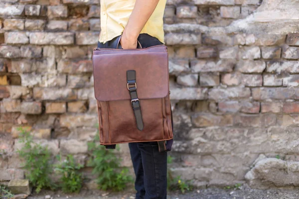 Man Holding Brown Leather Backpack Hand Unisex Bags Sale — Stock Photo, Image
