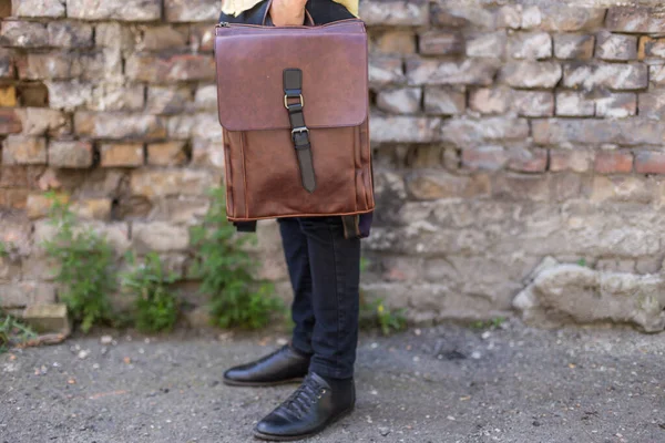 Man Holding Brown Leather Backpack Hand Unisex Bags Sale — Stock Photo, Image