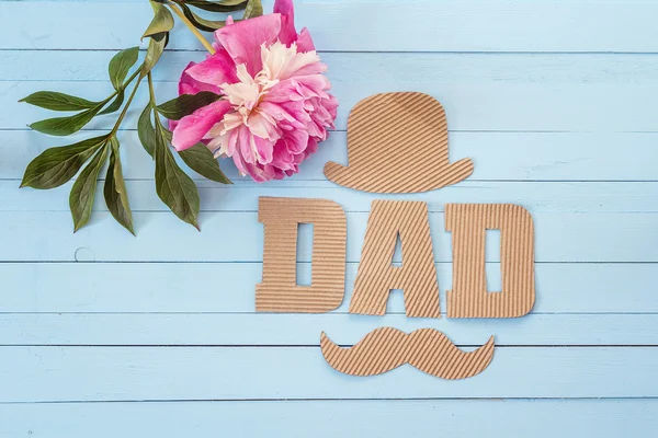 Fathers day background with cardboard letters and purple peony o