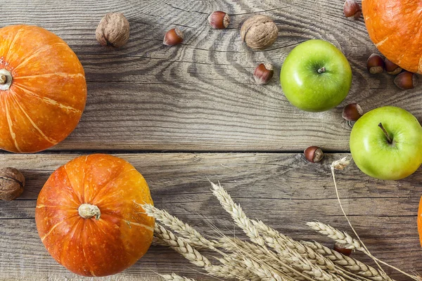 Fondo con calabazas, nueces, manzanas y espigas de trigo en viejo — Foto de Stock