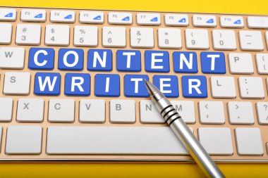 Content Writer on laptop keys with pen closeup clipart