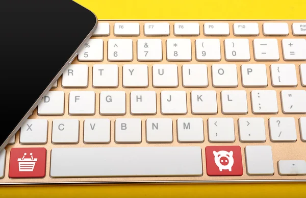 Smartphone and keyboard with shopping icon close up
