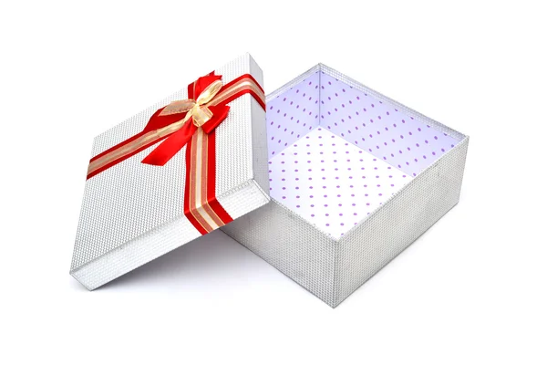 Empty silver gift box with red ribbon — Stock Photo, Image