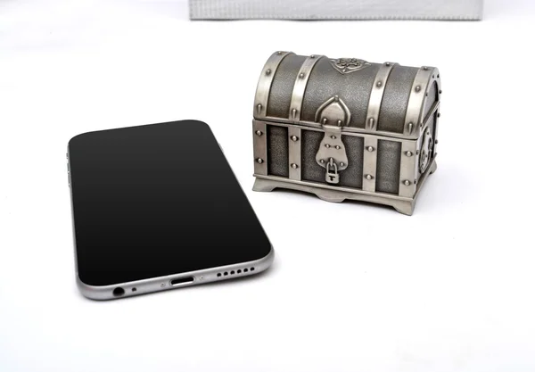 Old Treasure box with smartphone isolated — Stock Photo, Image