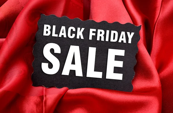 Black Friday Sale Tag with red Silk Background — Stock Photo, Image