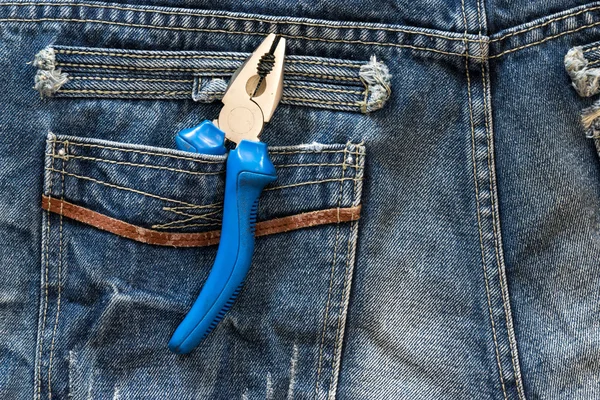 Wire cutting plier in blue jeans pocket. — Stock Photo, Image