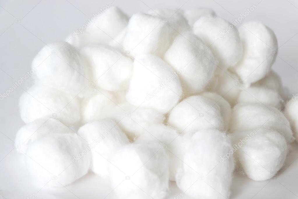 Group of cotton balls on white background.