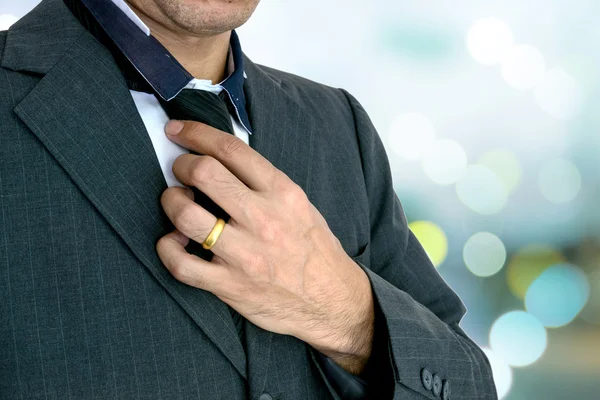 Young business man on lighting background. — Stock Photo, Image