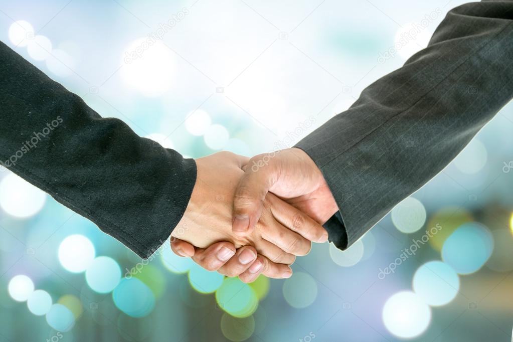 Business man and woman holding hands.