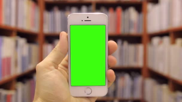 Telefone inteligente na biblioteca tipo de tela verde — Vídeo de Stock