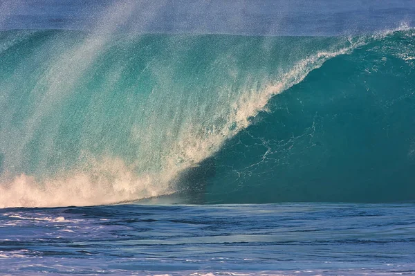 Surfing giant waves at Pipeline on the north shore of Oahu Hawaii