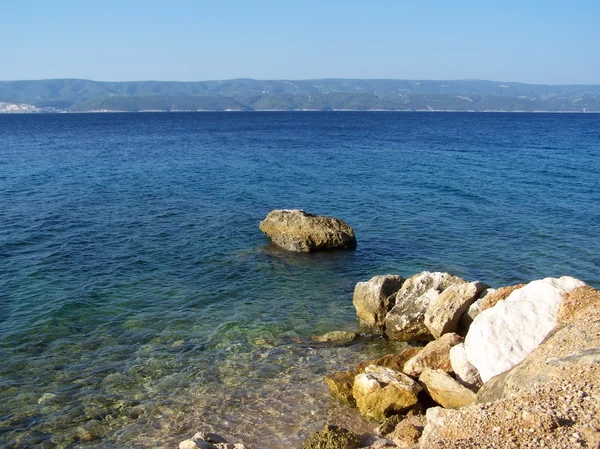 Plage croate avec rochers géants et petits cailloux — Photo