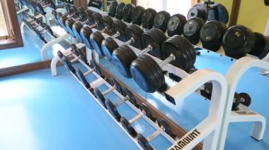 dumbell satırlarının görünümünü bir spor salonunda bir raf üzerinde