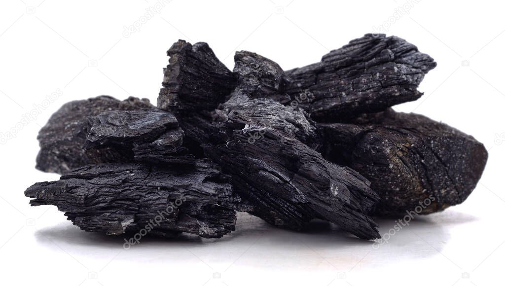 Pile of charcoal isolated on a white background.