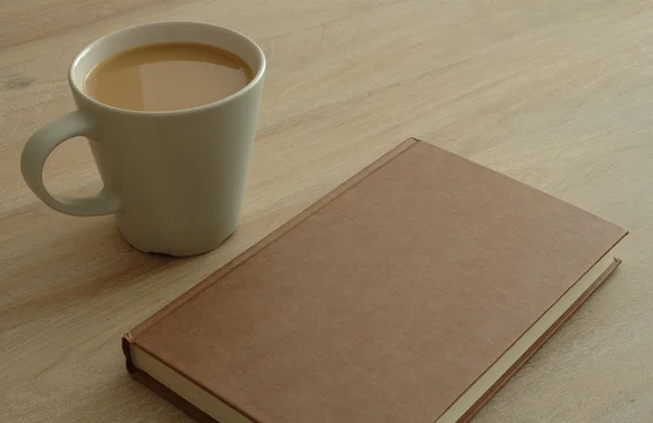 Book and coffee on a table — Stock Photo, Image