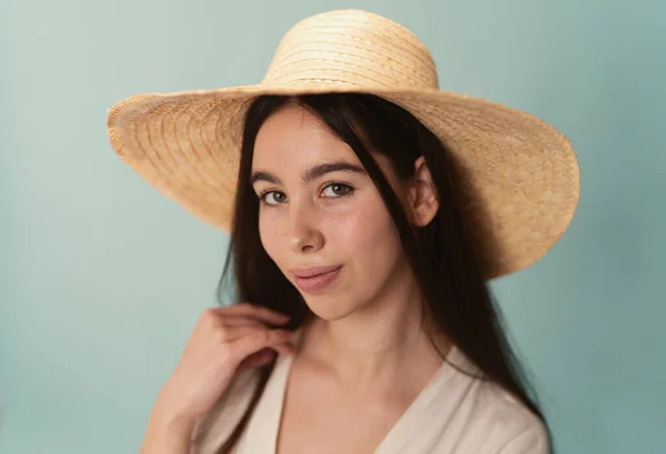 Romantic portrait of smiling female in straw hat and stylish linen dress. Royalty Free Stock Photos