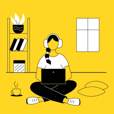 The girl is sitting on the floor with her legs crossed at home with a laptop, working, studying remotely online. In the background there is a shelf with a plant, books, a window. Next a cup of coffee.