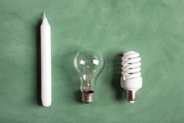 White candle and electric bulbs — Stock Photo, Image