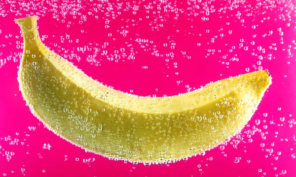 Yellow banana surrounded by bubbles — Stock Photo, Image