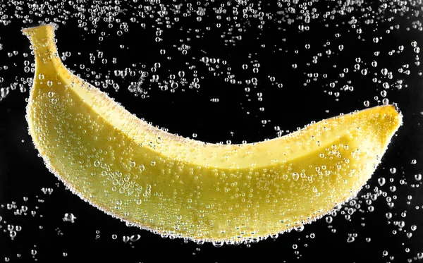 Yellow banana surrounded by bubbles — Stock Photo, Image