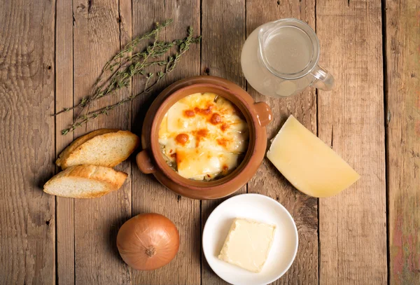 Onion soup on the rustic table — Stock Image Onion soup on the rustic table Stock Photo
