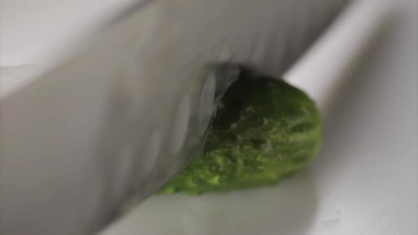 Slicing cucumber with knife — Stock Video