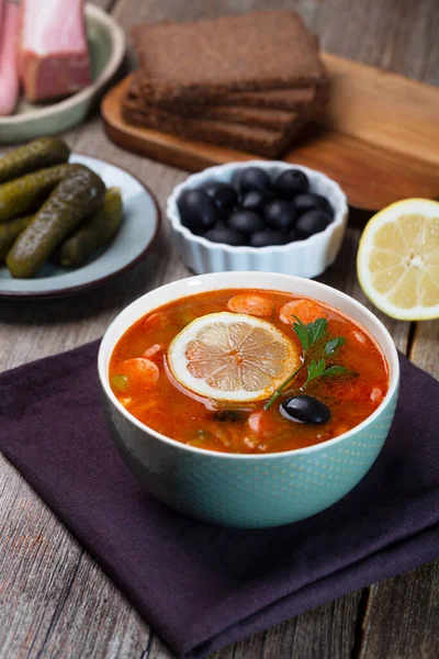 Solyanka, Russian soup with sausage, olives, pickled cucumber and capers — Stock Image Solyanka Russian Soup Sausage Olives Pickled Cucumber Capers Stock Photo